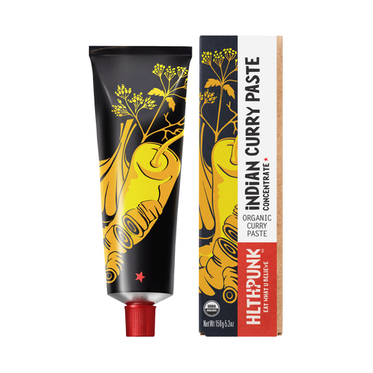 Packaging of Indian Curry Chili Paste, featuring a tube and a box with a yellow and black design and spice illustrations.
