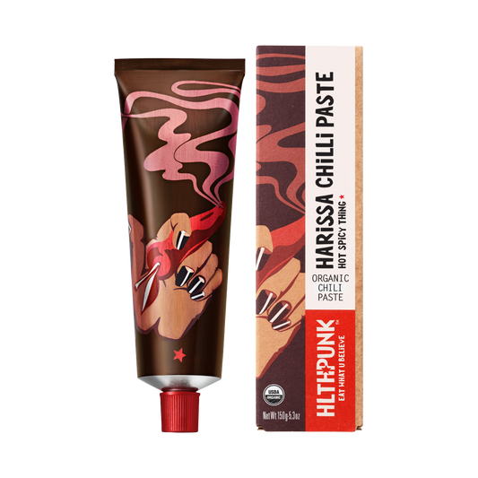 Packaging of Smoked Harissa Deep Spice, featuring a tube and box with red and orange colors and harissa paste illustration.