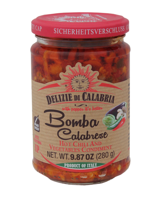 A jar of 'Bomba Calabrese' hot chili and vegetables condiment by Delizie Di Calabria with a red cap on a plain background.
