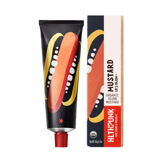 Packaging of Hot Dijon Mustard featuring a tube and a box with branding and mustard illustrations.