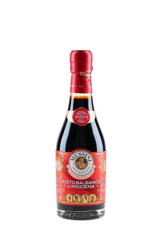 Bottle of Mussini Balsamic Vinegar on a white background