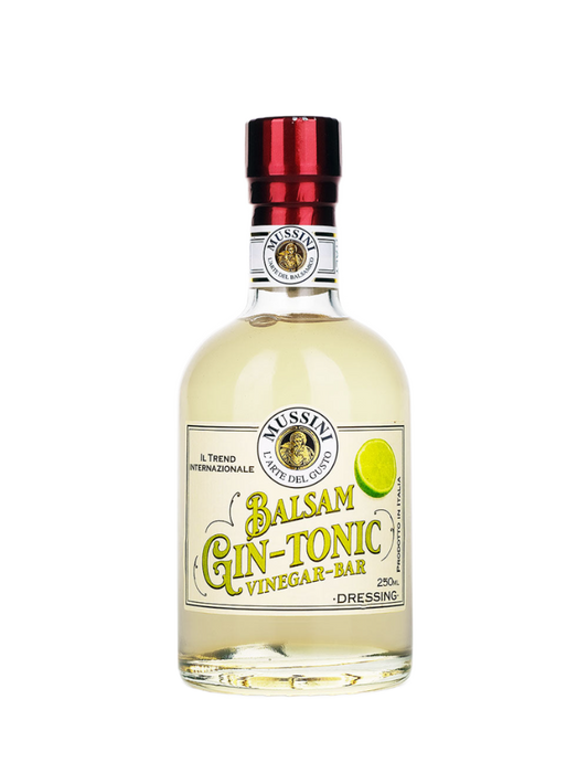 A bottle of Gin and Tonic Balsamic Vinegar by Mussini with a label that shows the product name and a lemon slice, indicating a flavored balsamic vinegar cocktail mix.