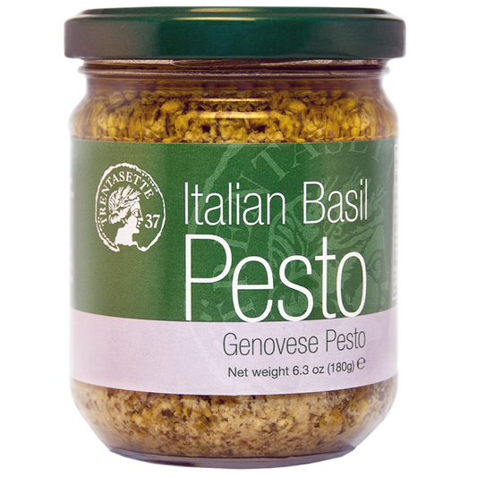 A jar of Italian Basil Pesto Genovese, with a green label and visible basil leaves.