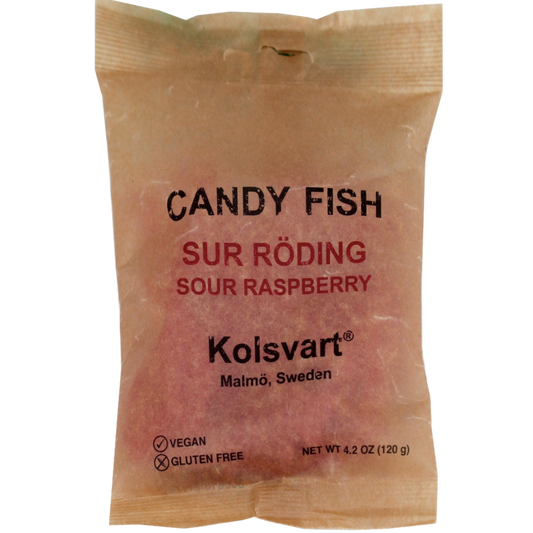 Packaging of Kolsvart Sour Raspberry Swedish Fish, with a clear window showing the raspberry-flavored candy inside. The package is labeled with various dietary claims such as vegan, gluten-free, and preservative-free.