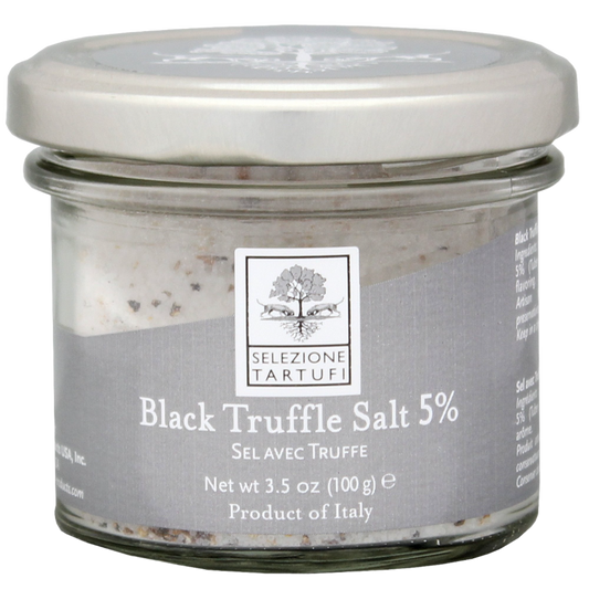 A glass jar containing black truffle salt with a label indicating 'Black Truffle Salt 5% Truffle', product weight of 3.5oz (100gm), and 'Selezione Tartufi' branding.