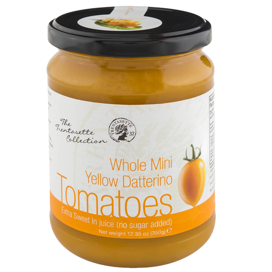 A jar of Yellow Datterino Tomato in Juice with the label showing the product name and a illustration of a tomato. The jar is part of The Fruit’s Collection.