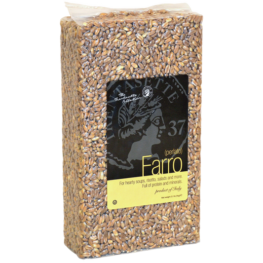 Packaged Farro grains in a clear plastic bag with a black and yellow label displaying the product name and weight.