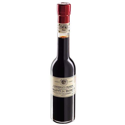 A bottle of Mussini Wildberry Flavored Balsamic Vinegar with a red cap, labeled with the brand and product name.