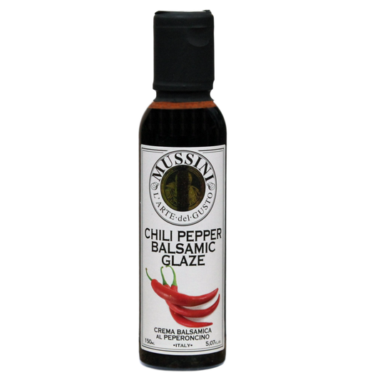 Bottle of Mussini Chili Pepper Balsamic Glaze with a label showing the product name and an image of a chili pepper.