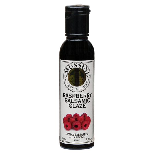 Bottle of Mussini Raspberry Balsamic Glaze with a label showing raspberries and text indicating the flavor and product size of 5.1oz (150ml).
