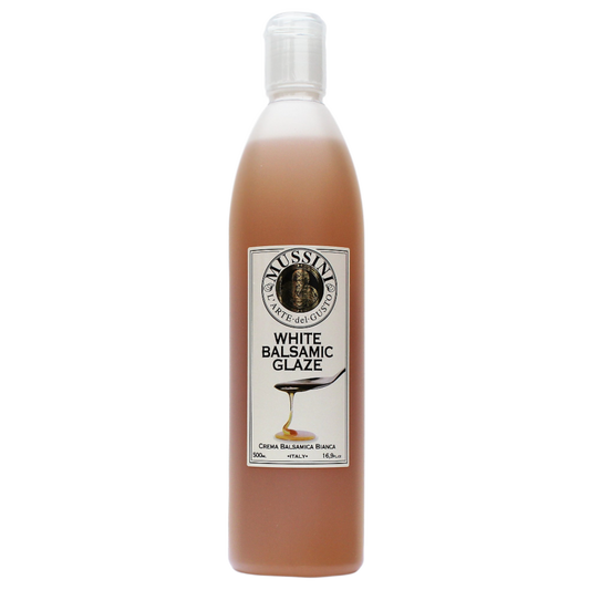 Bottle of Mussini White Balsamic Glaze with a label showing the product name and volume.