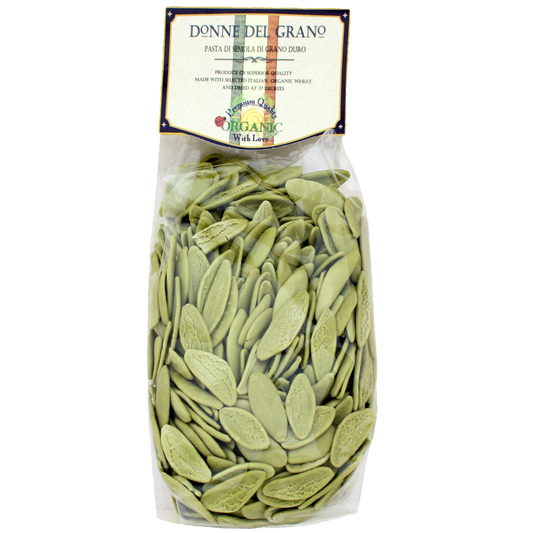 Packaged organic green olive leaf pasta named 'Foglie d'Oliva' by Donne Del Grano, displayed in a clear plastic container with a label showing the brand and product name.
