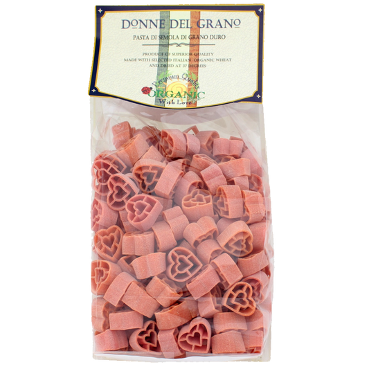Packaged red heart-shaped pasta called 'Cuoricini' by Donne Del Grano, made from durham wheat and natural paprika.