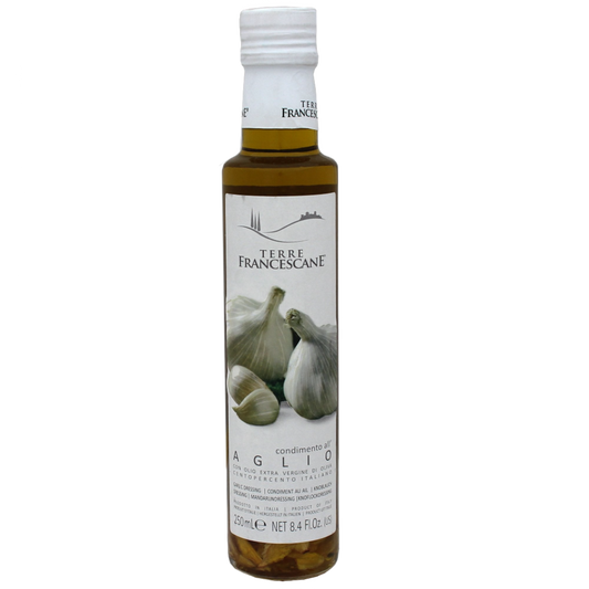 Bottle of Terre Francescane garlic infused extra virgin olive oil with a label showing garlic and the brand name.