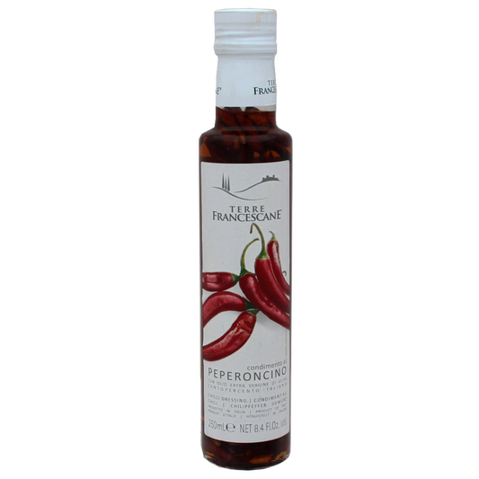 Bottle of Terre Francescane Pepper Infused Extra Virgin Olive Oil with a label showing red peppers and indicating the flavor and origin.